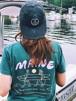 a woman wearing a green hat with Thread the Gnar's embroidery on it