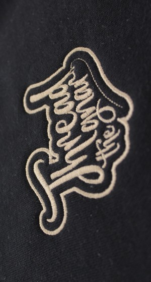 an image of the Thread the Gnar logo, in gold, sewn out onto a hat